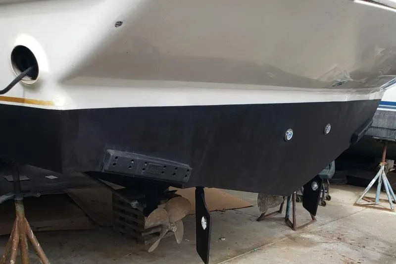 Slide: The Image of 1991 Wellcraft Triumph 34 boat hull on stands, showing propellers and rudders. - 18