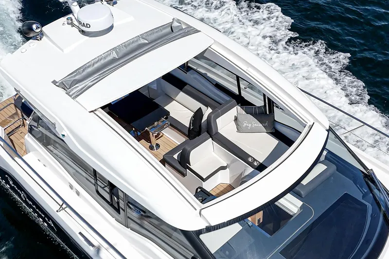 Slide: The Image of 2023 Bavaria SR36 yacht cruising on open water, featuring sleek design and spacious seating area. - 32