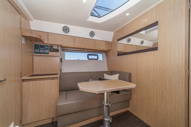 Slide: The Image of 2023 Bavaria SR36 interior with modern wood finish, skylight, and cozy seating area. - 44