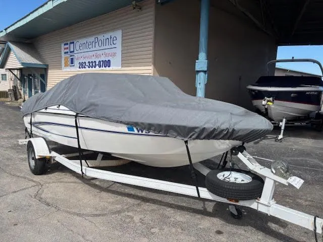 Slide: The Image of 2005 Glastron MX 175 boat on trailer, covered, parked at CenterPointe storage facility. - 1