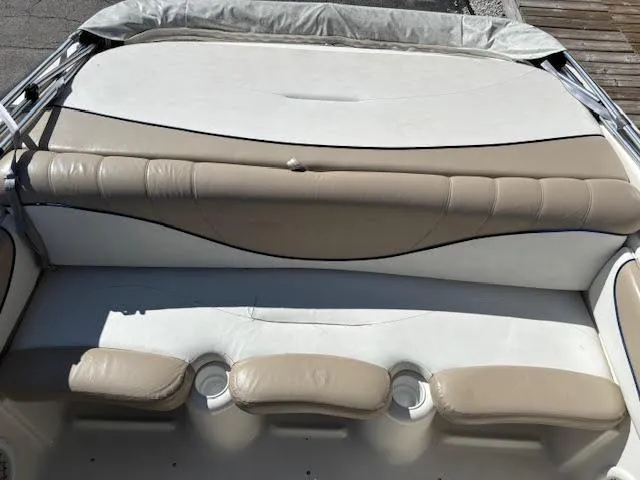 Slide: The Image of 2005 Glastron MX 175 boat interior with beige seating and cup holders. - 11