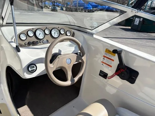Slide: The Image of 2005 Glastron MX 175 boat dashboard with steering wheel and instrument panel. - 16