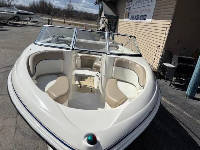 Slide: The Image of 2005 Glastron MX 175 boat with beige seating, parked outdoors. - 2