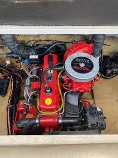 Slide: The Image of 2005 Glastron MX 175 boat engine, red and black components, detailed view. - 21