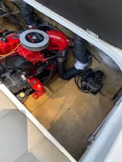 Slide: The Image of 2005 Glastron MX 175 boat engine compartment with visible red engine components. - 22