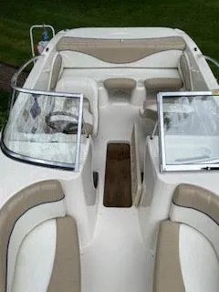 Slide: The Image of 2005 Glastron MX 175 boat interior with beige seating and open windshield. - 3