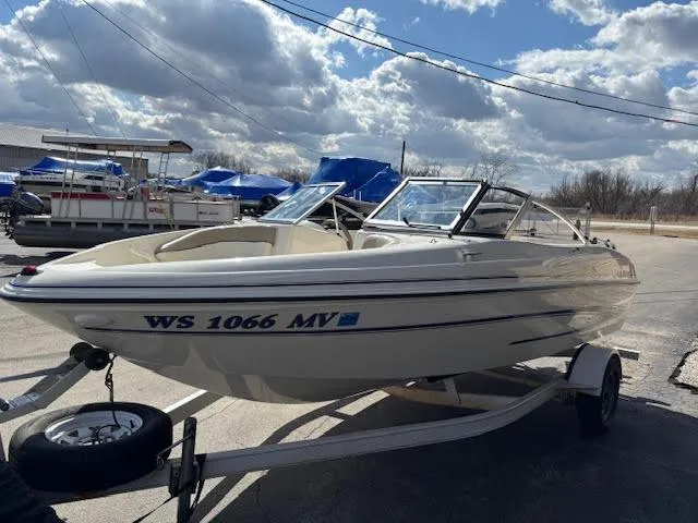 Slide: The Image of 2005 Glastron MX 175 boat on trailer under cloudy sky. - 4