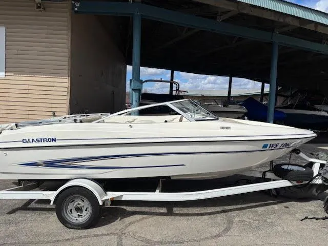 Slide: The Image of 2005 Glastron MX 175 boat on trailer, parked under a shelter. - 8