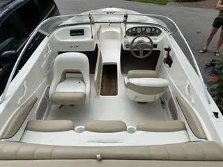 Slide: The Image of 2005 Glastron MX 175 boat interior with beige seating and steering console. - 9