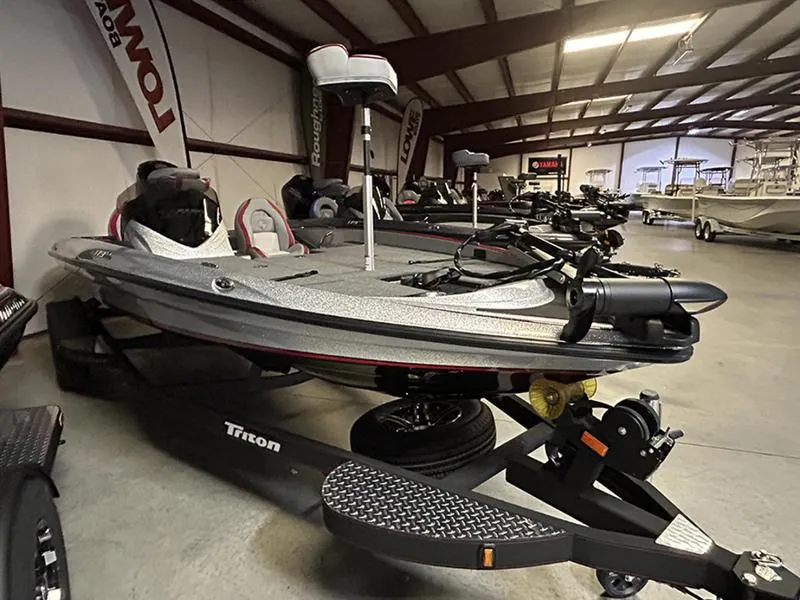 Slide: The Image of 2023 Triton 179 TrX bass boat in showroom, featuring sleek design and advanced fishing equipment. - 6