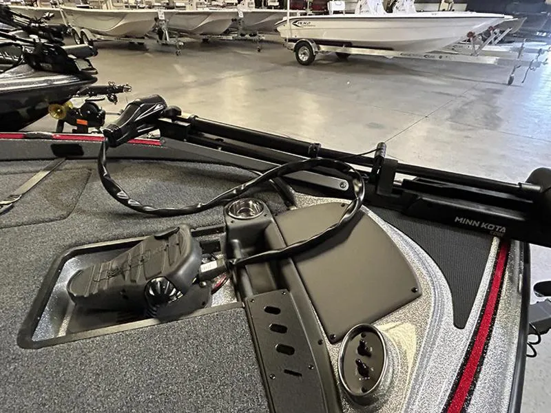 Slide: The Image of 2023 Triton 179 TrX boat with Minn Kota trolling motor in a showroom. - 7