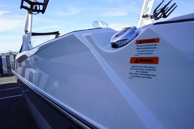 Slide: The Image of 2019 Axis A22 boat side view with warning labels and sleek design. - 10