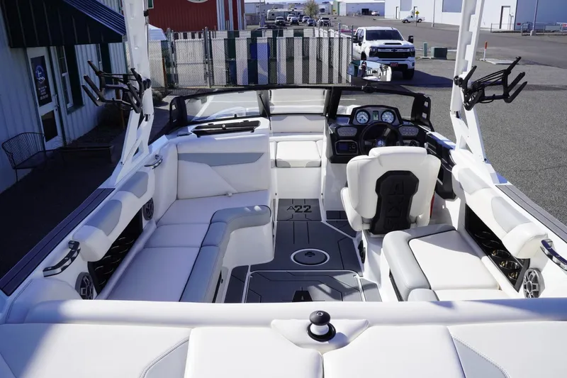 Slide: The Image of 2019 Axis A22 boat interior with white seating and modern dashboard. - 11