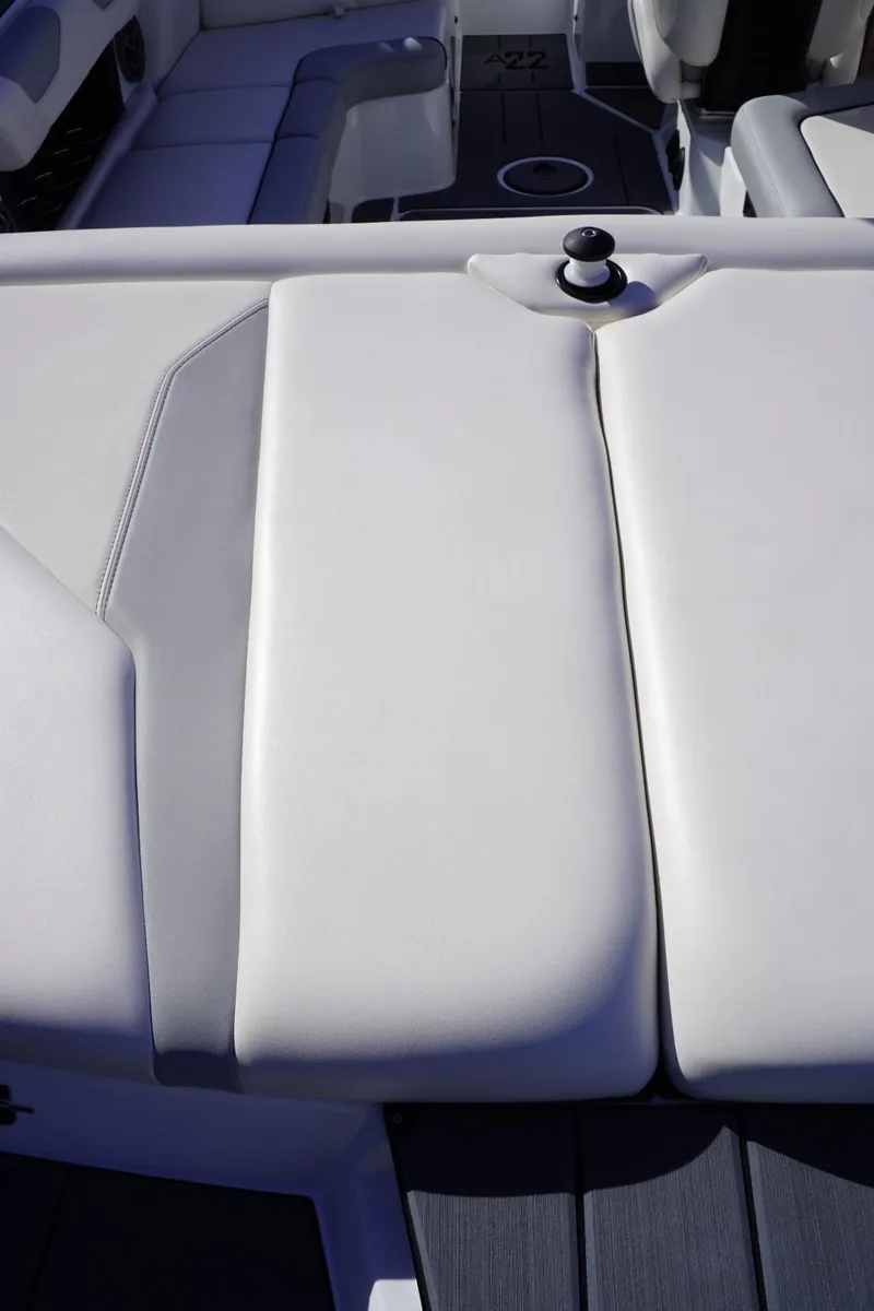 Slide: The Image of 2019 Axis A22 boat interior with white and gray seating. - 12