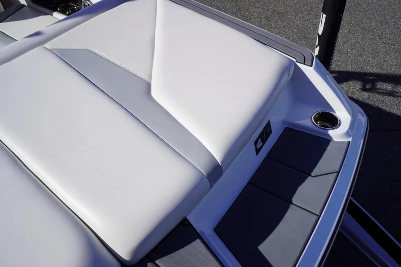 Slide: The Image of 2019 Axis A22 boat with sleek white and gray seating and cup holder. - 14