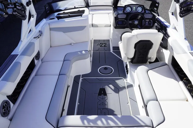 Slide: The Image of 2019 Axis A22 boat interior with white seating and modern dashboard. - 16