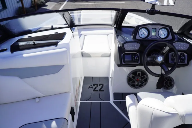 Slide: The Image of 2019 Axis A22 boat interior with steering wheel and dashboard controls. - 17