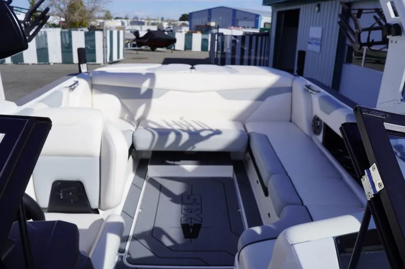 Slide: The Image of 2019 Axis A22 boat interior with white seating and spacious layout. - 18