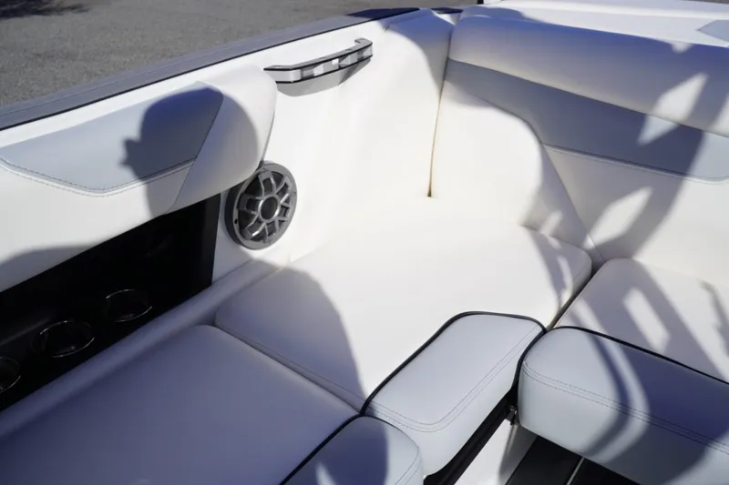 Slide: The Image of 2019 Axis A22 boat interior with white seating and speaker. - 21