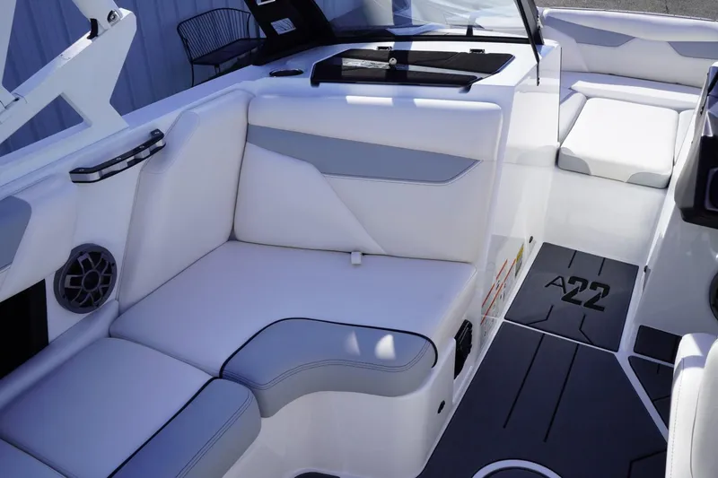 Slide: The Image of 2019 Axis A22 boat interior with white seating and modern design. - 22