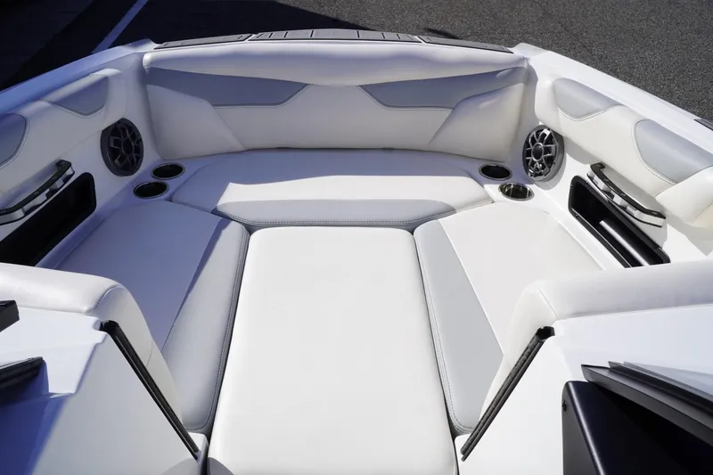 Slide: The Image of 2019 Axis A22 boat interior with white seating and built-in speakers. - 23