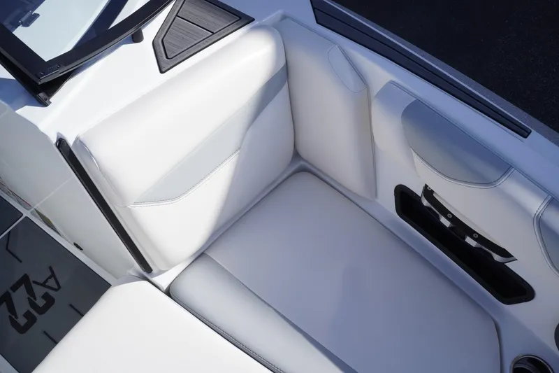 Slide: The Image of 2019 Axis A22 boat interior with white cushioned seating. - 28