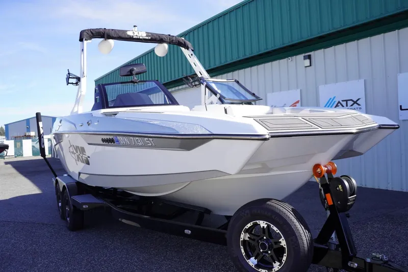 Slide: The Image of 2019 Axis A22 boat on trailer, parked outside a building. - 3