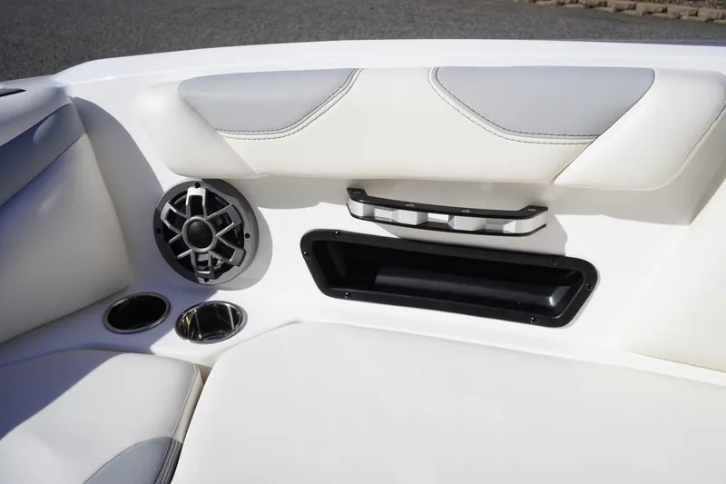 Slide: The Image of 2019 Axis A22 boat interior with speaker, cup holder, and storage compartment. - 30