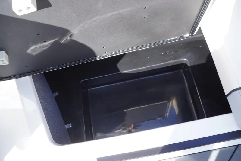 Slide: The Image of 2019 Axis A22 boat storage compartment, open and empty, with a black interior. - 32