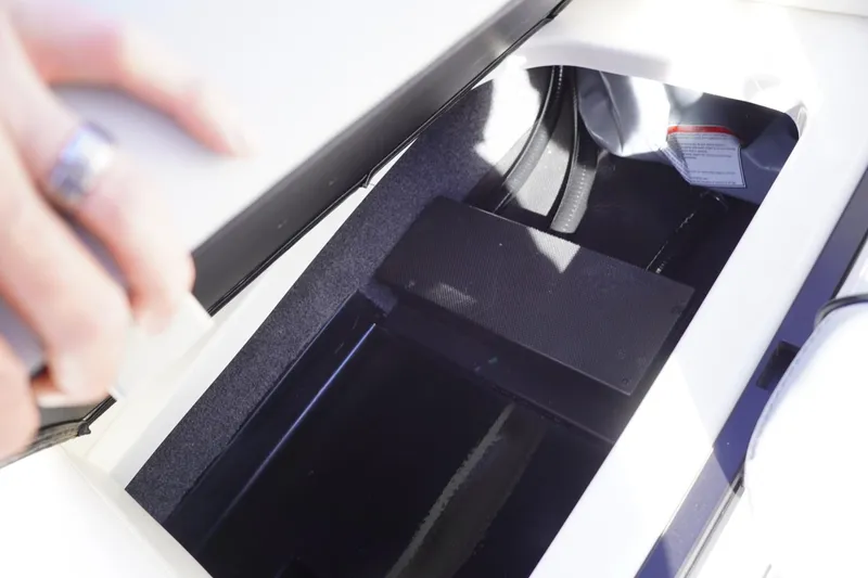 Slide: The Image of 2019 Axis A22 storage compartment with open lid, showing interior details. - 33