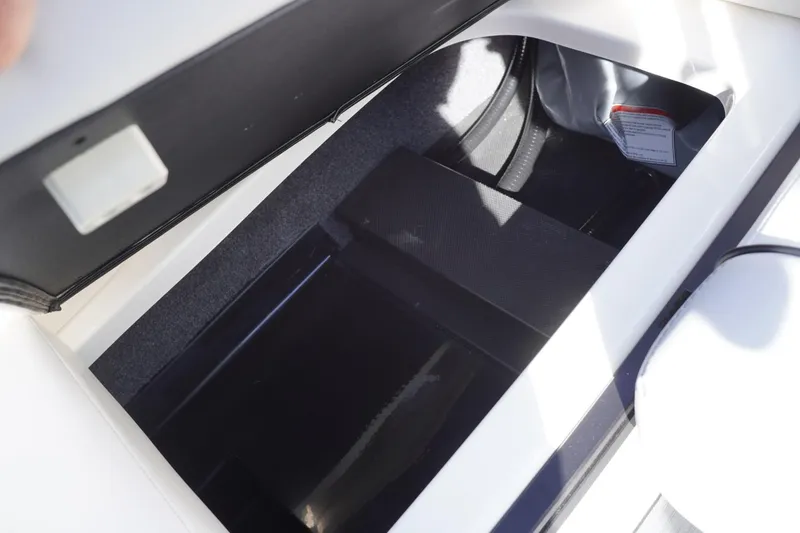 Slide: The Image of 2019 Axis A22 boat storage compartment with open lid, showcasing interior space. - 34