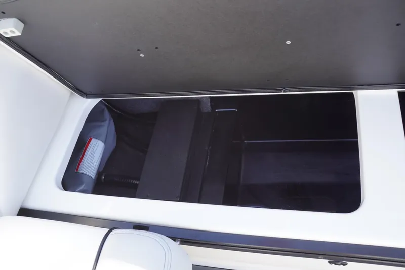 Slide: The Image of 2019 Axis A22 boat storage compartment with open lid, showcasing interior space. - 35