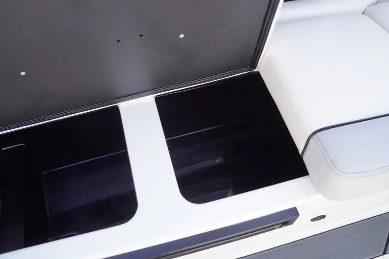 Slide: The Image of 2019 Axis A22 boat storage compartment with open lid and white seating. - 36