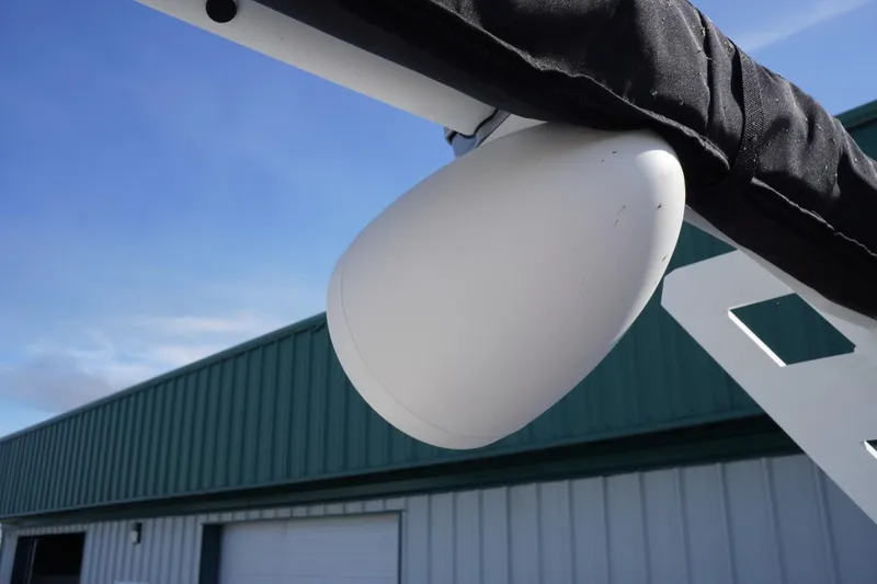 Slide: The Image of 2019 Axis A22 boat speaker against blue sky and green building background. - 44