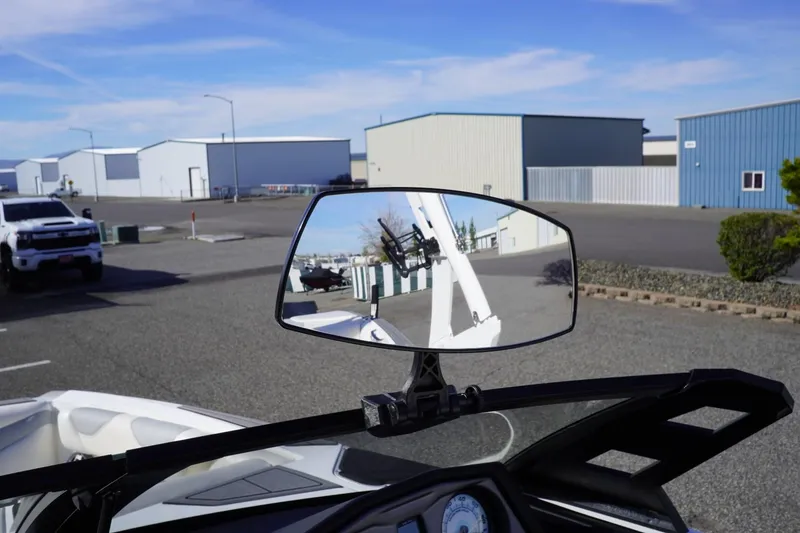 Slide: The Image of 2019 Axis A22 boat mirror reflecting industrial buildings and parked vehicles. - 48