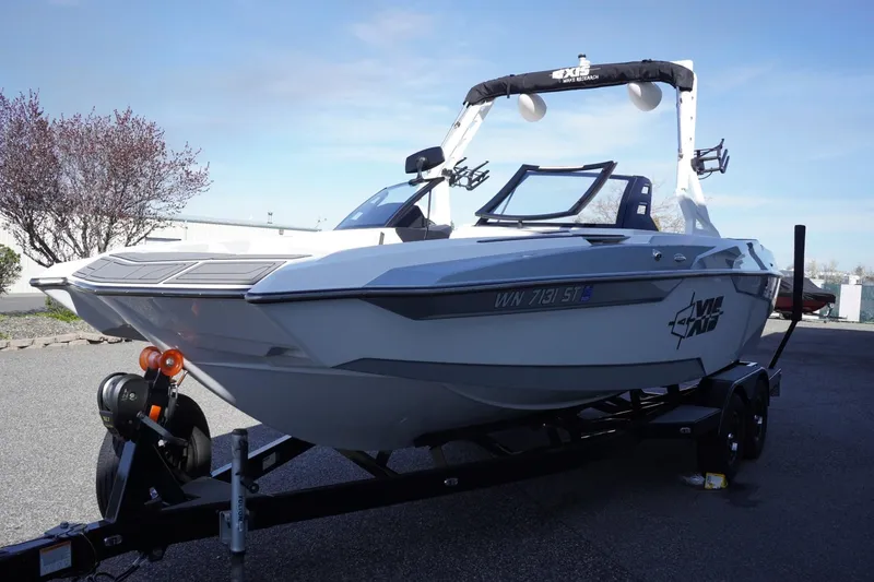Slide: The Image of 2019 Axis A22 boat on trailer, parked outdoors under clear sky. - 5
