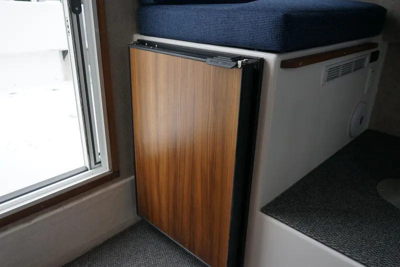 Slide: The Image of Compact wooden cabinet in 2025 Sea Sport 26' Aleutian boat interior. - 13