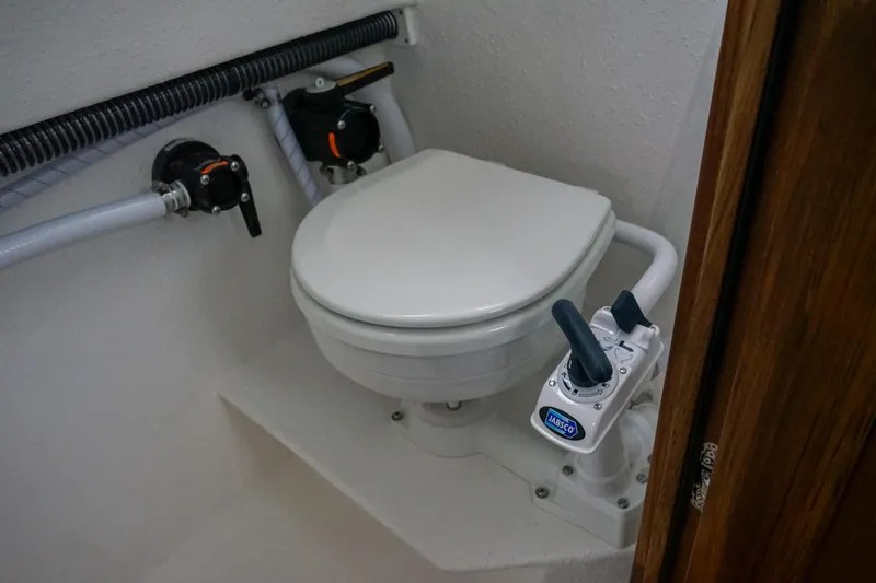 Slide: The Image of Marine toilet in 2025 Sea Sport 26' Aleutian boat, featuring compact design and manual flush system. - 17