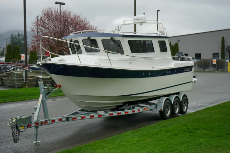 Slide: The Image of 2025 Sea Sport 26' Aleutian boat on a trailer, parked outdoors. - 19