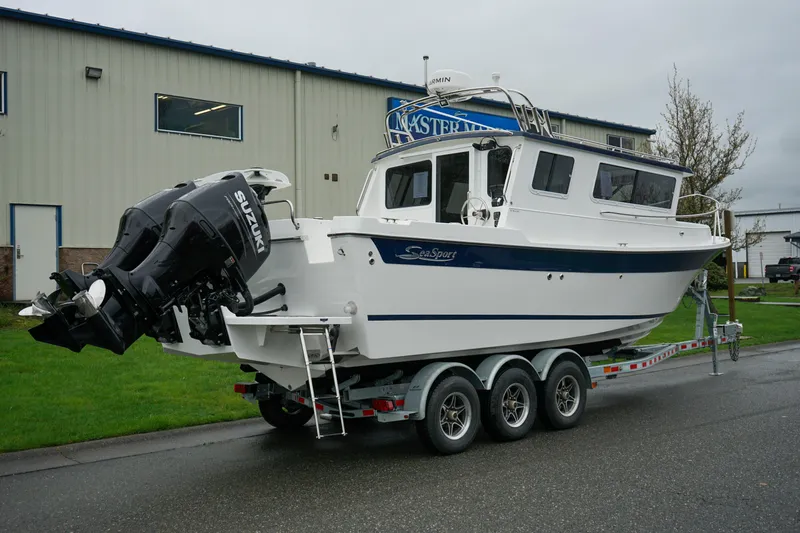 Slide: The Image of 2025 Sea Sport 26' Aleutian boat on trailer with Suzuki outboard motor. - 3