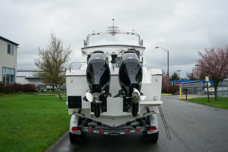Slide: The Image of 2025 Sea Sport 26' Aleutian boat on trailer, featuring dual outboard motors. - 4