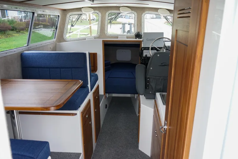 Slide: The Image of Interior of 2025 Sea Sport 26' Aleutian boat with seating and helm. - 6