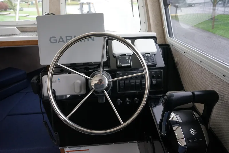 Slide: The Image of Steering wheel and controls of 2025 Sea Sport 26' Aleutian boat with Garmin navigation. - 8