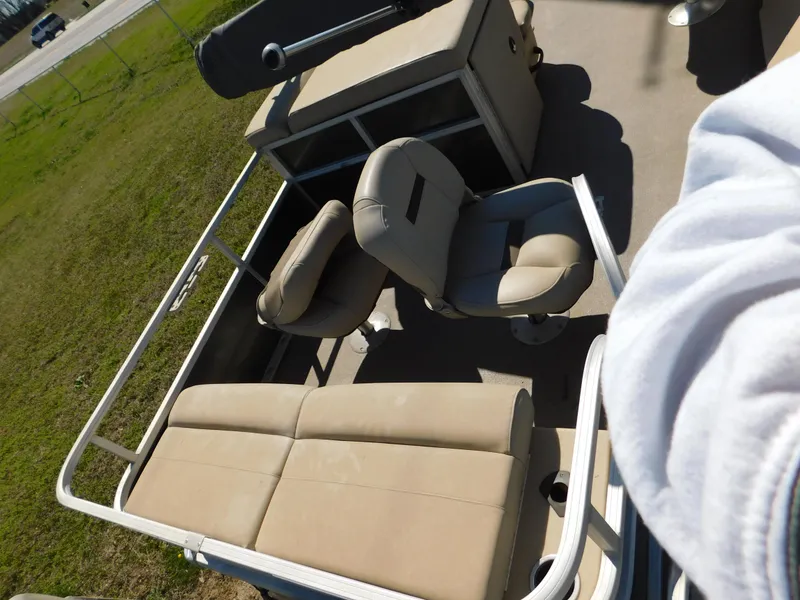 Slide: The Image of 2017 Sun Tracker Fishin' Barge 22 XP3 with beige seating and storage compartments. - 4