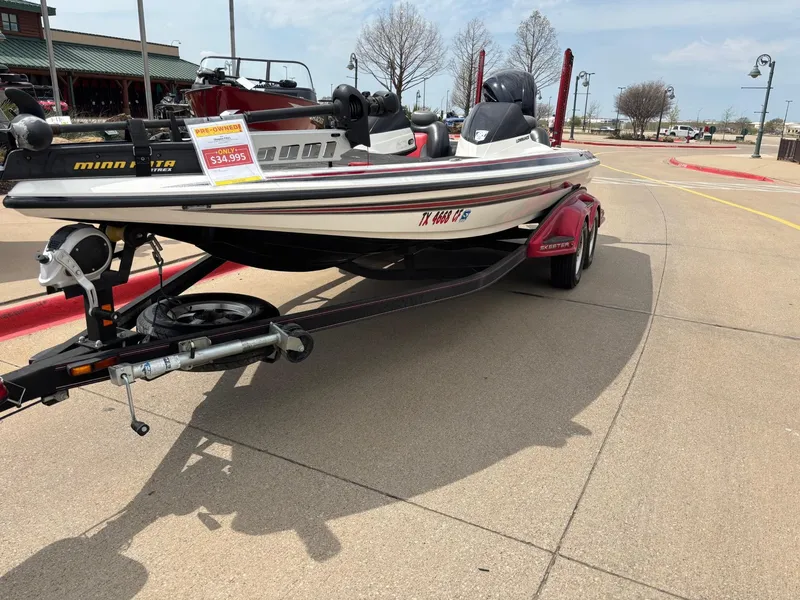 Slide: The Image of 2012 Skeeter FX21 boat on trailer, displayed outdoors with price tag. - 2