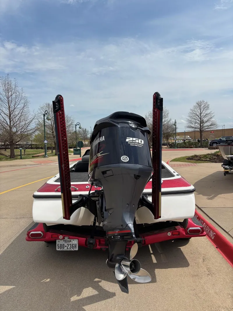 Slide: The Image of 2012 Skeeter FX21 boat with Yamaha 250 engine, parked on a trailer. - 4