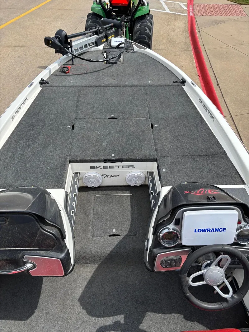 Slide: The Image of 2012 Skeeter FX21 bass boat deck with Lowrance electronics and trolling motor. - 5
