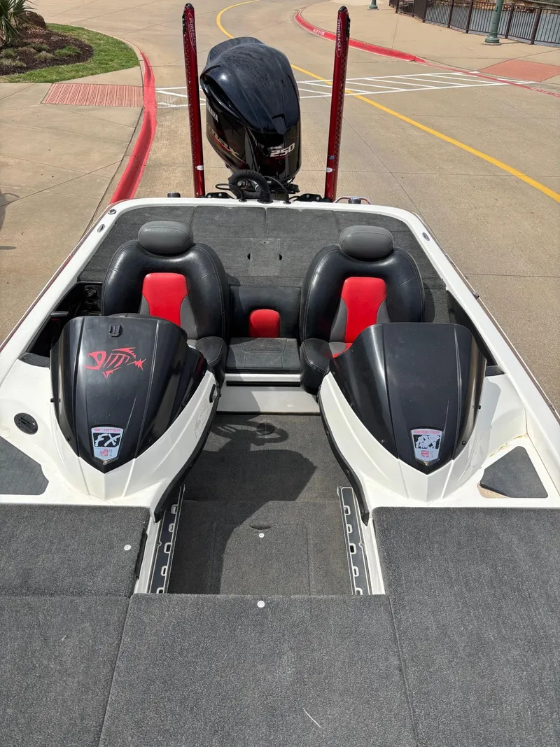 Slide: The Image of 2012 Skeeter FX21 bass boat with dual seats and outboard motor. - 6