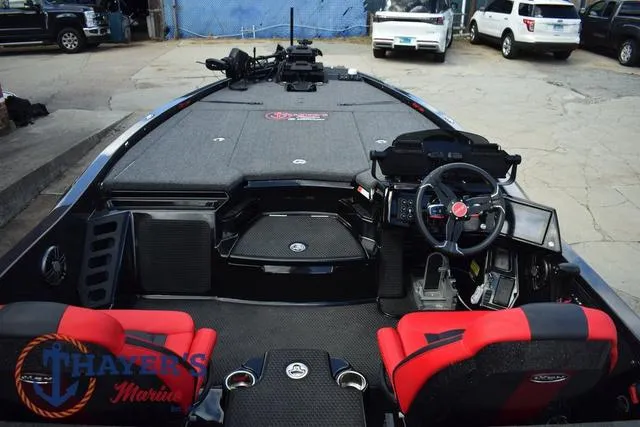 Slide: The Image of 2024 Ikon Boats LX21 interior with steering wheel, red seats, and dashboard controls. - 11