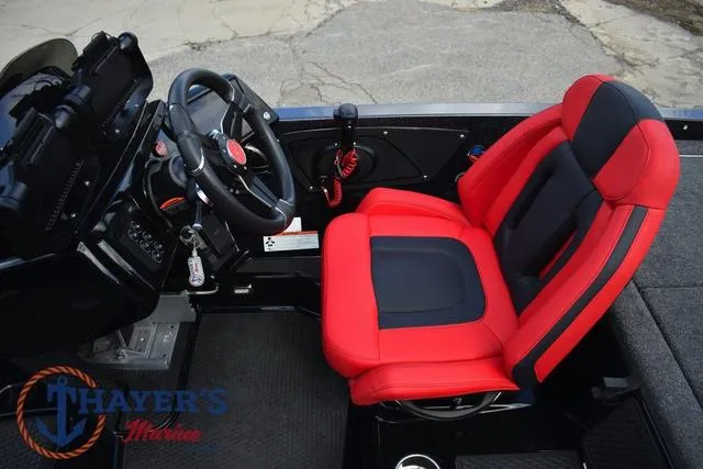 Slide: The Image of 2024 Ikon Boats LX21 interior with red and black seating, steering wheel, and controls. - 13